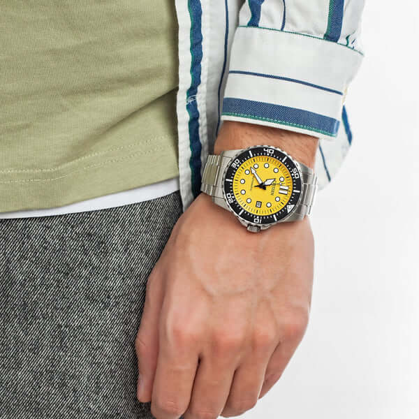 CITIZEN Mod. CLASSIC Automatic - YELLOW NJ0170-83Z on wrist with a yellow dial and stainless steel bracelet.